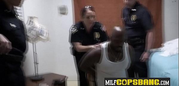  Black stud is banging two curvy MILFs with big tits in the interrogation room.